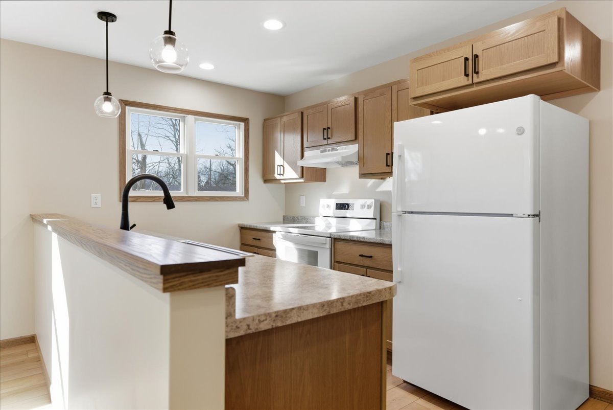 313 East Martin Street Forrest, IL 61741 - Photo 9 of 50 a kitchen with refrigerator and white cabinets