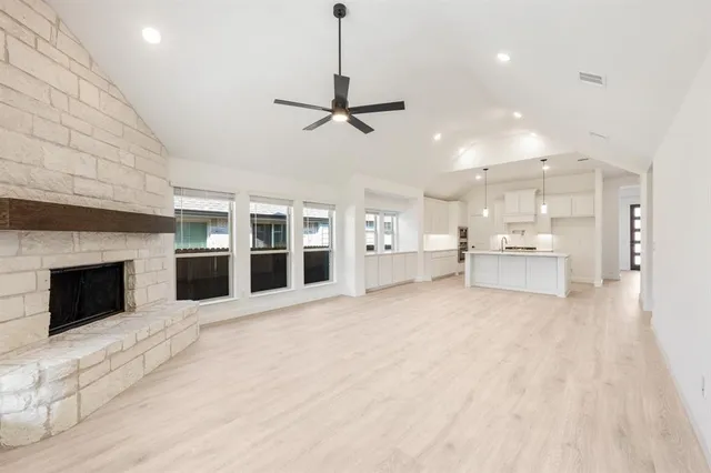 a view of a kitchen with a sink and a fireplace