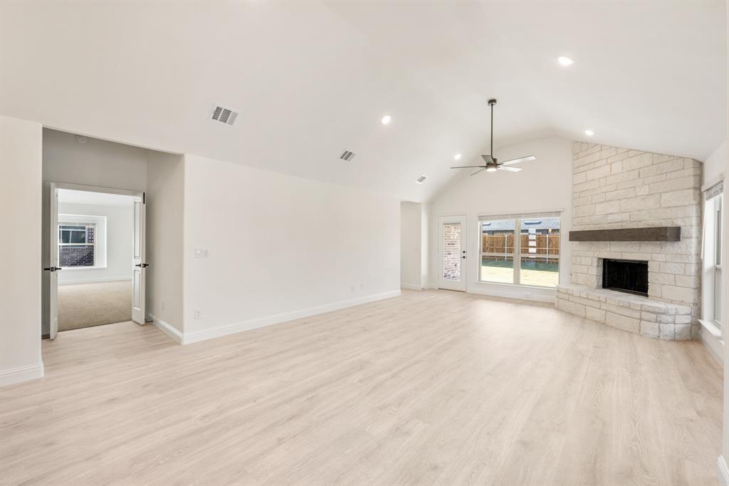 2009 Ambergate Drive Anna, TX 75409 - Photo 17 of 36 an empty room with kitchen and fireplace