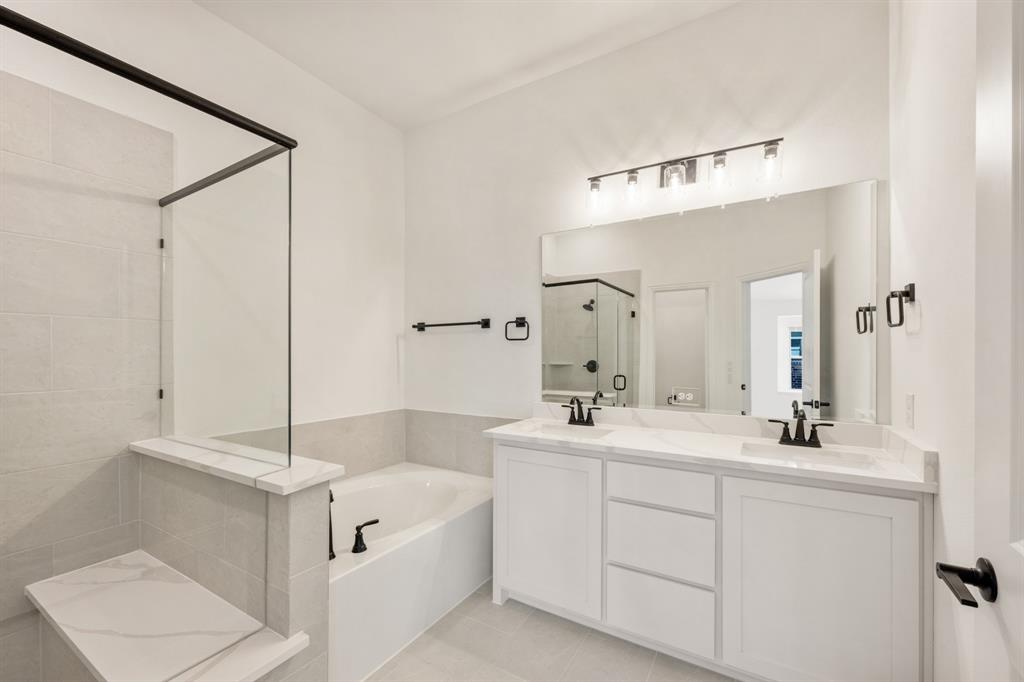 2009 Ambergate Drive Anna, TX 75409 - Photo 21 of 36 a bathroom with a double vanity sink mirror and bathtub