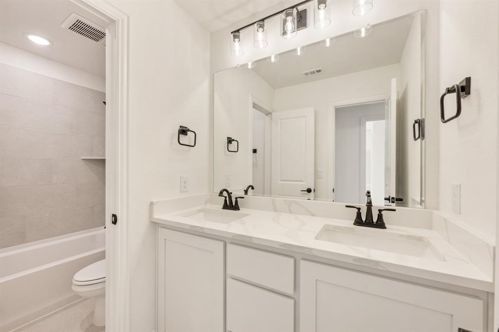 2009 Ambergate Drive Anna, TX 75409 - Photo 26 of 36 a bathroom with a sink a toilet and a mirror