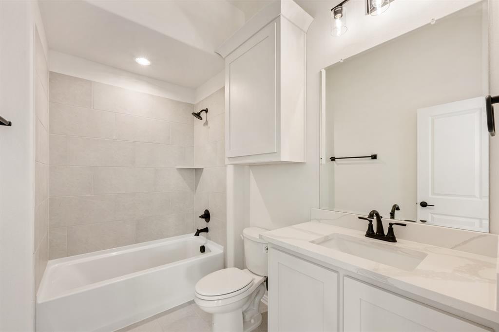 2009 Ambergate Drive Anna, TX 75409 - Photo 31 of 36 a bathroom with a bathtub shower sink vanity and toilet