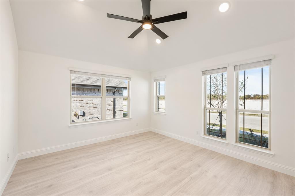 2009 Ambergate Drive Anna, TX 75409 - Photo 6 of 36 a view of an empty room with a window and wooden floor