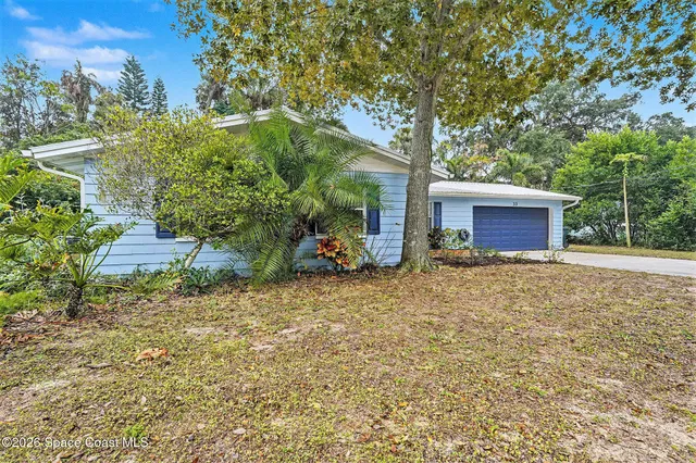 front view of a house with a tree
