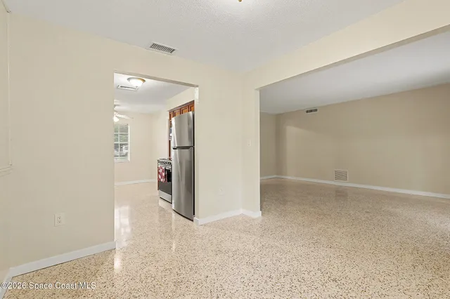 an empty room with windows and bathroom