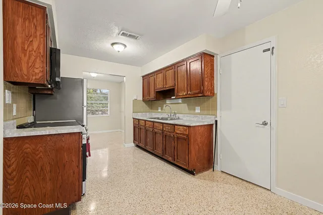 a kitchen with stainless steel appliances granite countertop a sink stove and cabinets