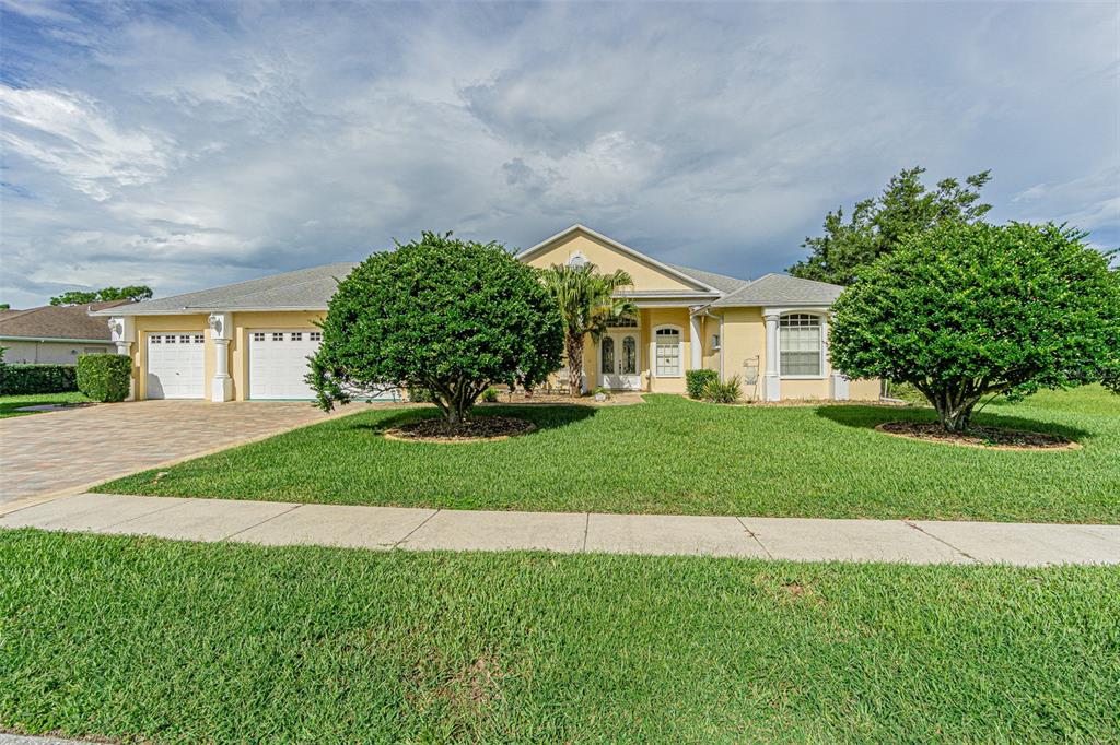 a front view of a house with a garden