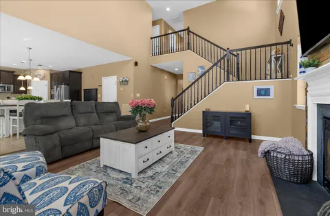a kitchen with stainless steel appliances granite countertop a sink a stove and a wooden cabinets