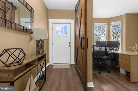a spacious bedroom with a bed and a flat screen tv