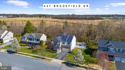 an aerial view of houses with outdoor space and lake view