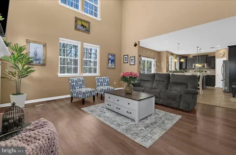 a living room with furniture and a chandelier
