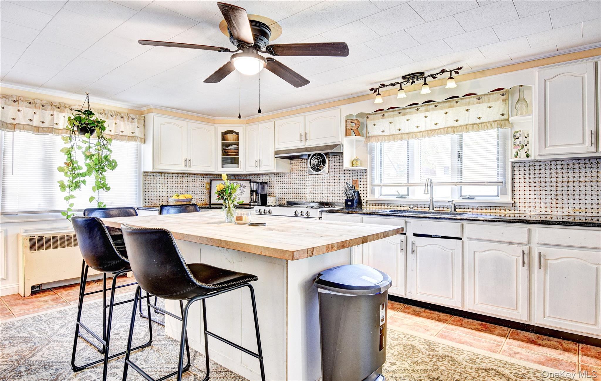 99 South Main Street Florida, NY 10921 - Photo 12 of 43 a kitchen with stainless steel appliances granite countertop white cabinets a sink and a large window