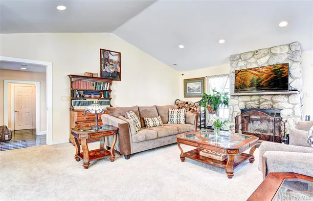 a living room with fireplace furniture and a flat screen tv