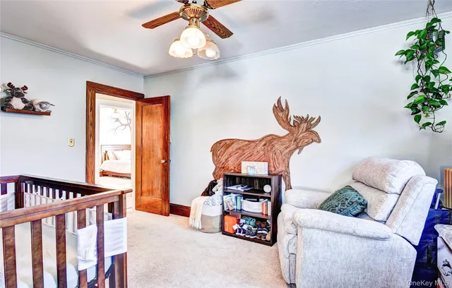 a bedroom with furniture and a potted plant