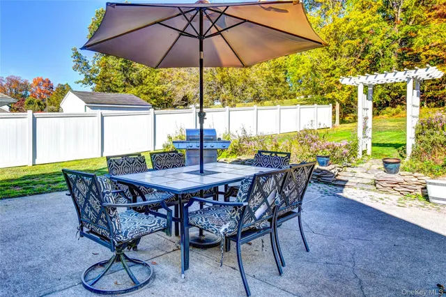 a view of an outdoor sitting area with furniture and umbrella