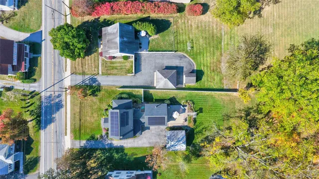 a front view of house with yard and green space