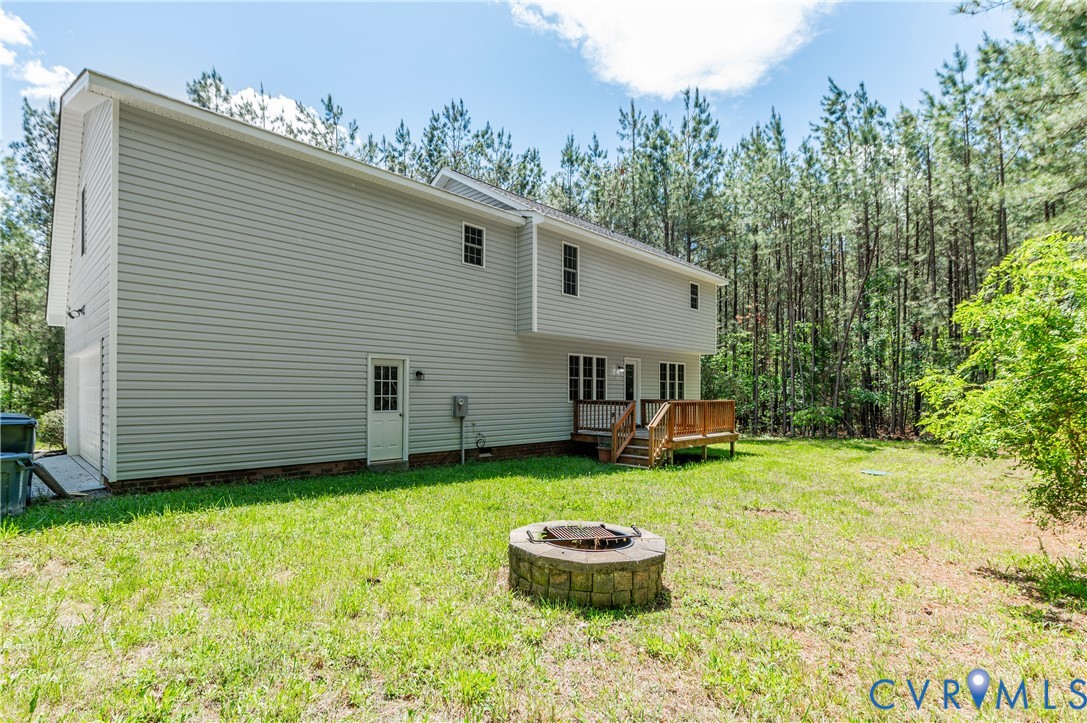 6320 Walnut Tree Drive Powhatan, VA 23139 - Photo 28 of 34 Back of house with a wooden deck, a lawn, crawl sp