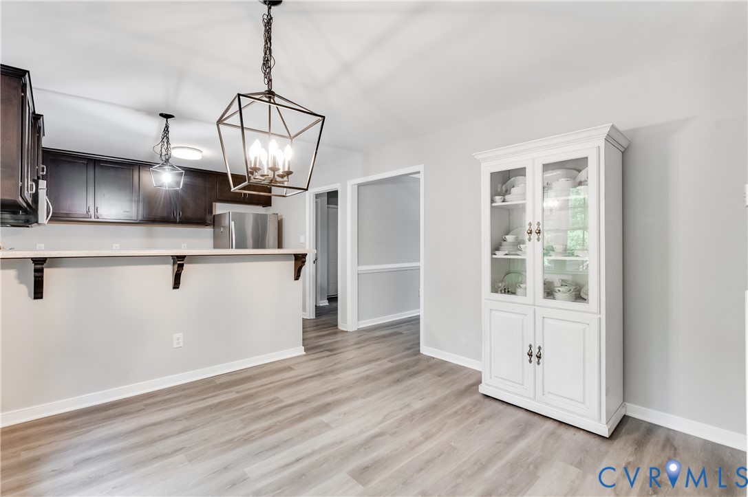 6320 Walnut Tree Drive Powhatan, VA 23139 - Photo 6 of 34 Kitchen with a peninsula, a chandelier, freestandi
