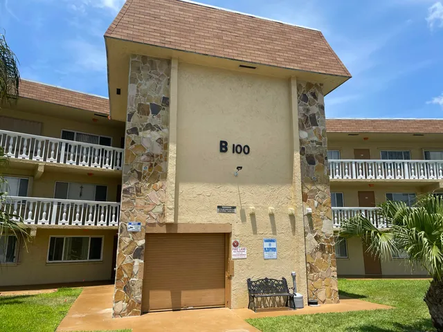 a front view of a building with garden