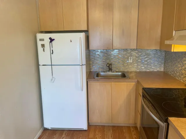 a white refrigerator freezer sitting in a kitchen