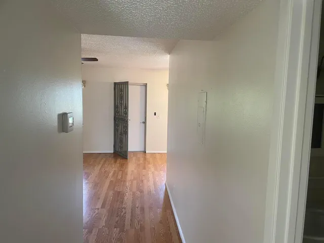 a view of a hallway with wooden floor