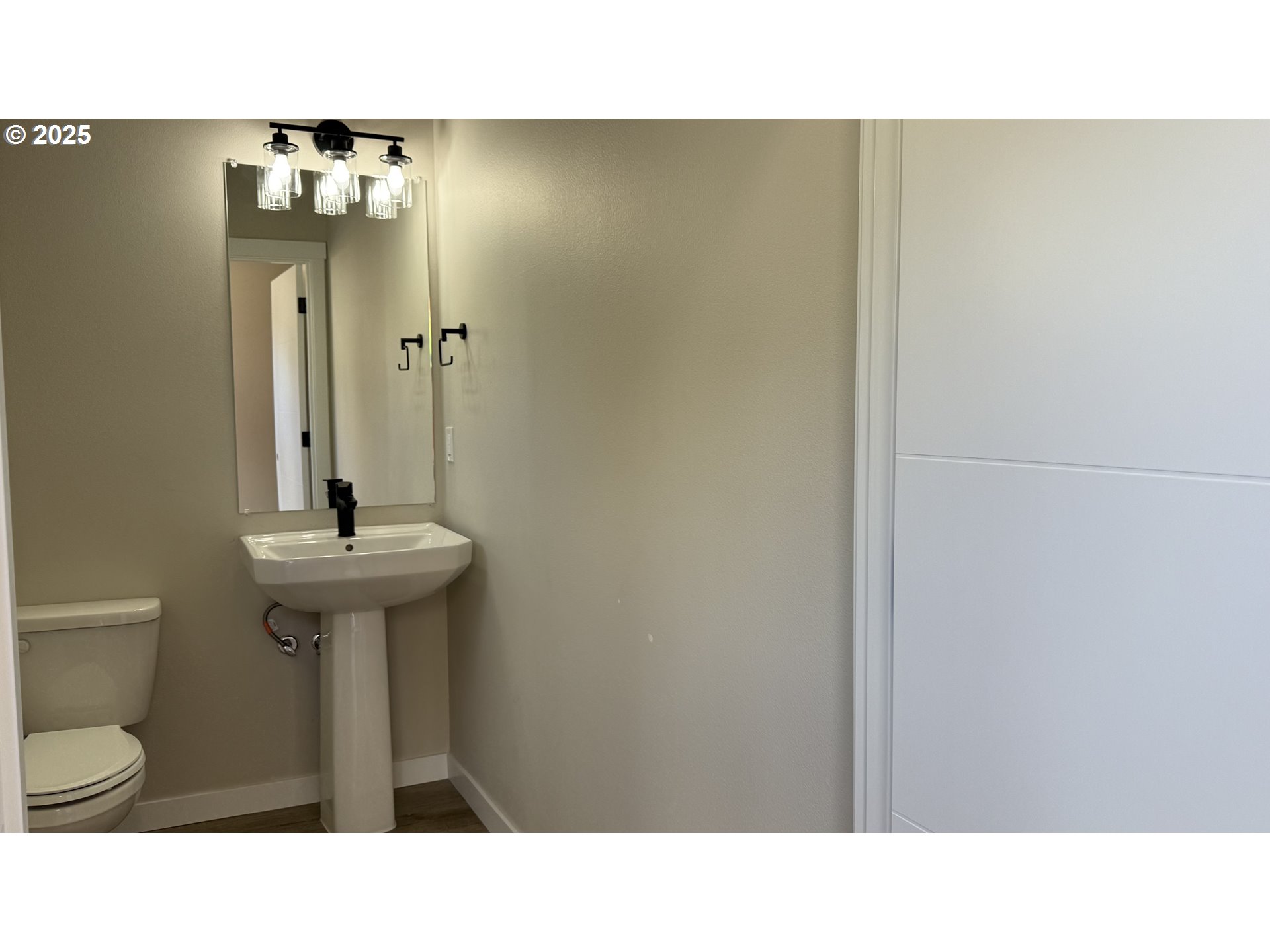 14362 Southeast Knight Street Portland, OR 97236 - Photo 3 of 15 a bathroom with a sink a toilet a mirror and vanity