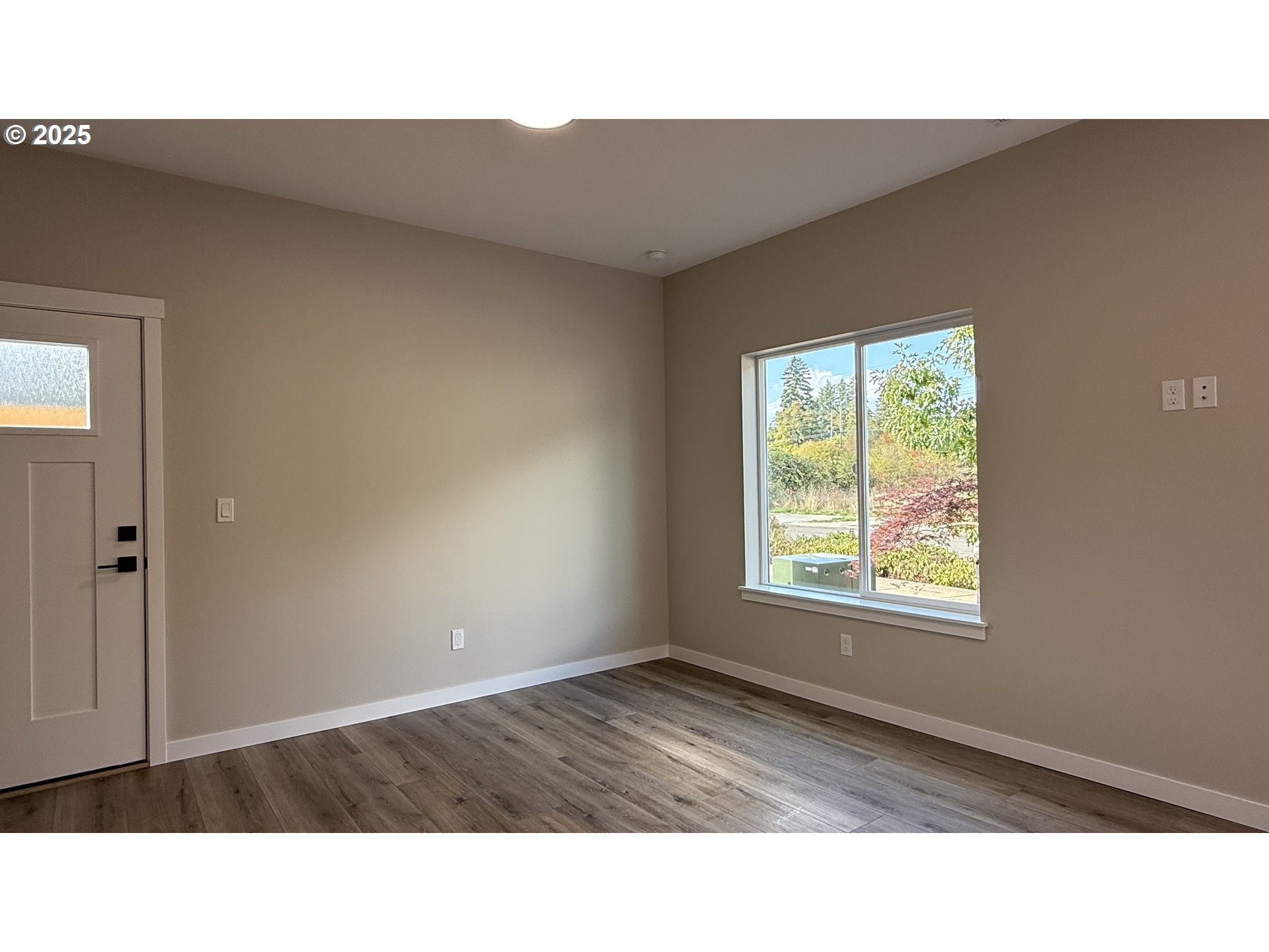 14362 Southeast Knight Street Portland, OR 97236 - Photo 5 of 15 a open hall with a hardwood floor and window