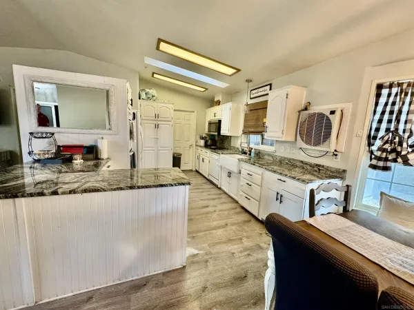 a kitchen with stainless steel appliances granite countertop a sink and a stove