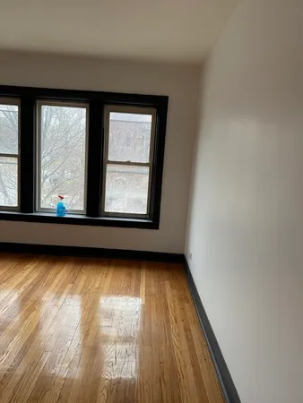 a view of a room with wooden floor and windows