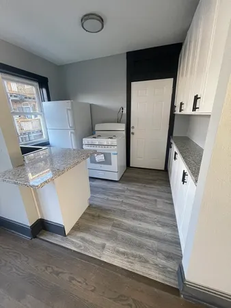 a view of kitchen with sink microwave and cabinets