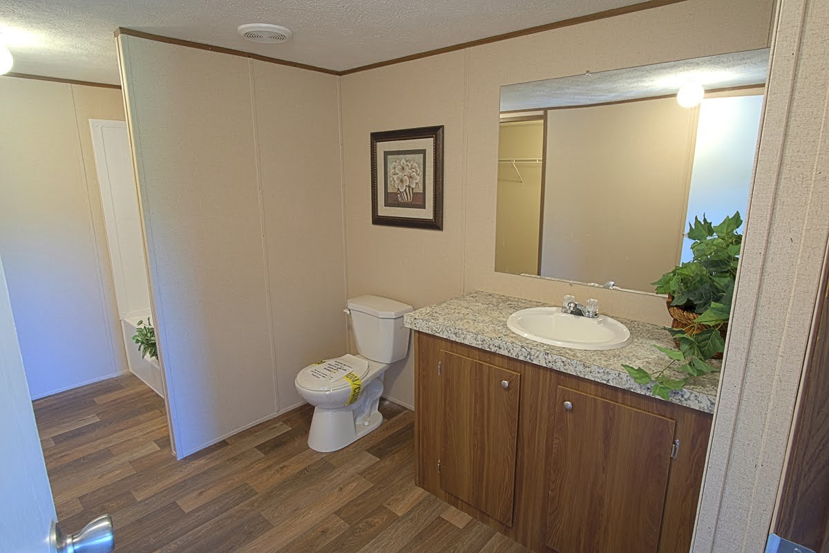 2402 Paul Harrell Road Beechgrove, TN 37018 - Photo 10 of 21 a bathroom with a granite countertop sink toilet and shower