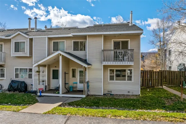 a front view of a house with a yard and porch