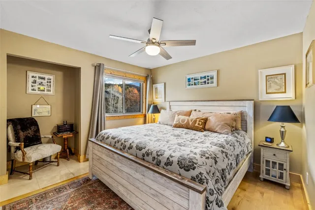 a bedroom with a bed and wooden floor