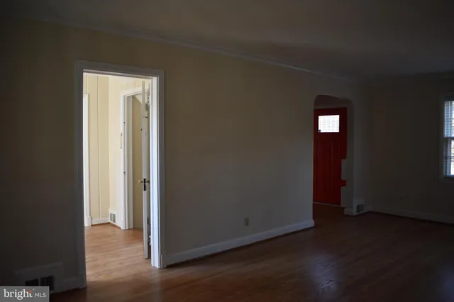 an empty room with wooden floor and closet