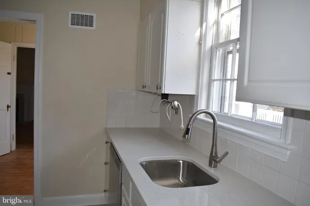 a kitchen with a sink and a window