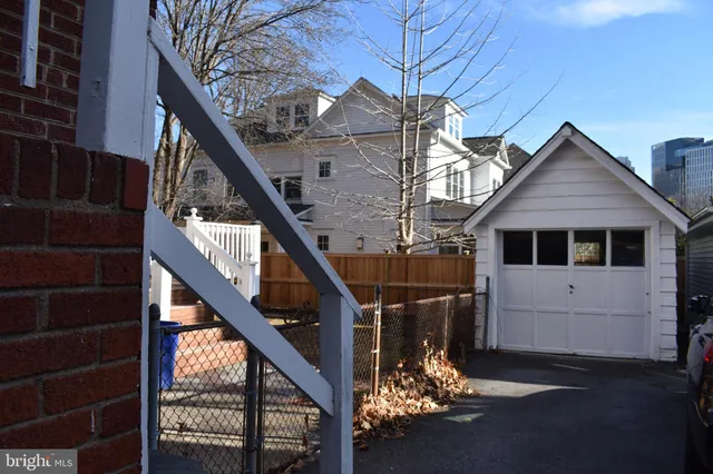 a view of a house with a small yard and potted plants