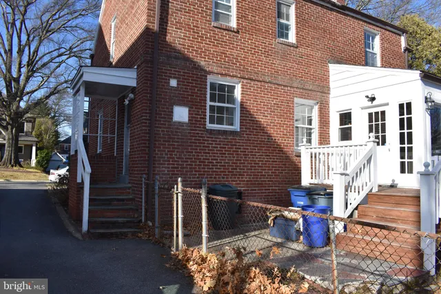 a brick building with a bench in front of it