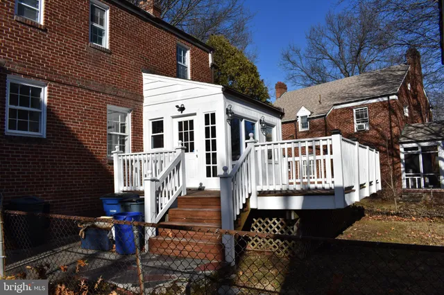 a view of a house with wooden deck