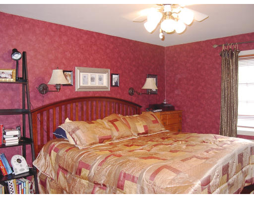 103 Field Road Longmeadow, MA 01106 - Photo 5 of 7 a bedroom with a bed and a chandelier