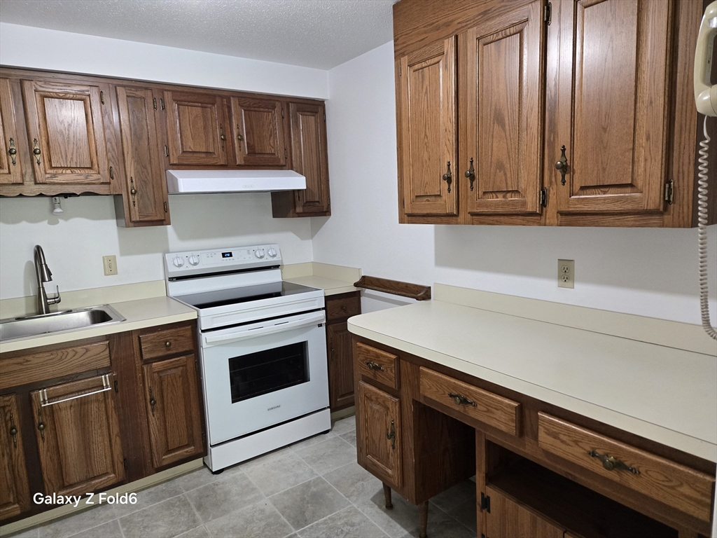 222 Buck Island Road, Unit 45 Yarmouth, MA 02673 - Photo 13 of 23 a kitchen with sink cabinets and stainless steel appliances