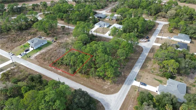 an aerial view of a house with a yard and greenery
