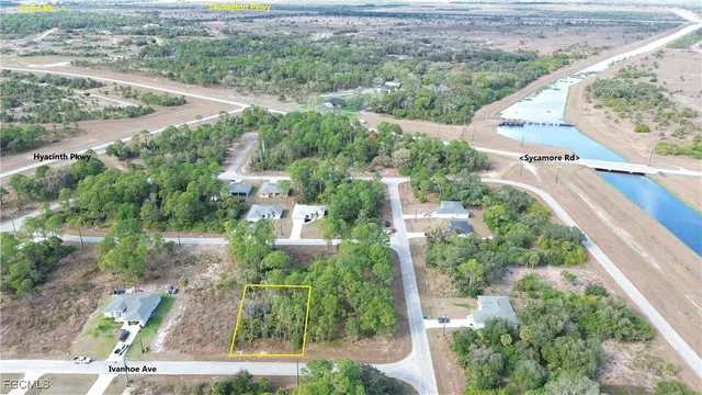 an aerial view of residential houses with outdoor space and street view