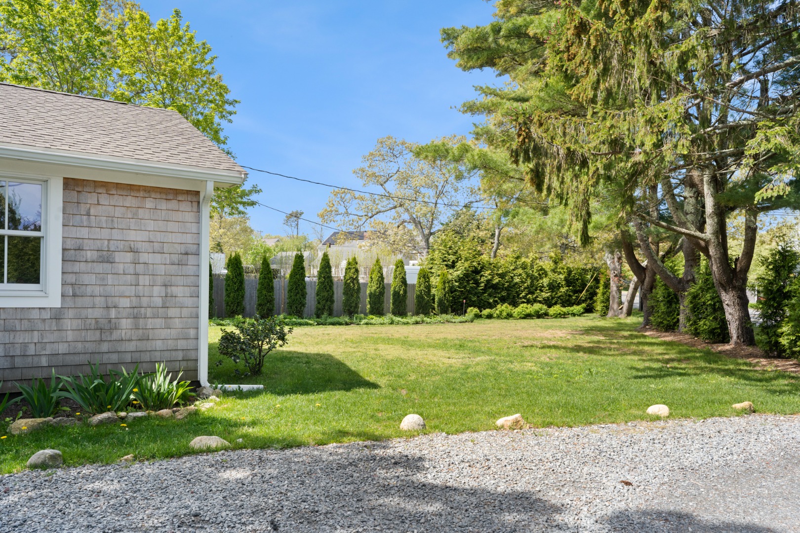 130 Wing Road Oak Bluffs, MA 02557 - Photo 19 of 21 Side yard with Wing Road at right.