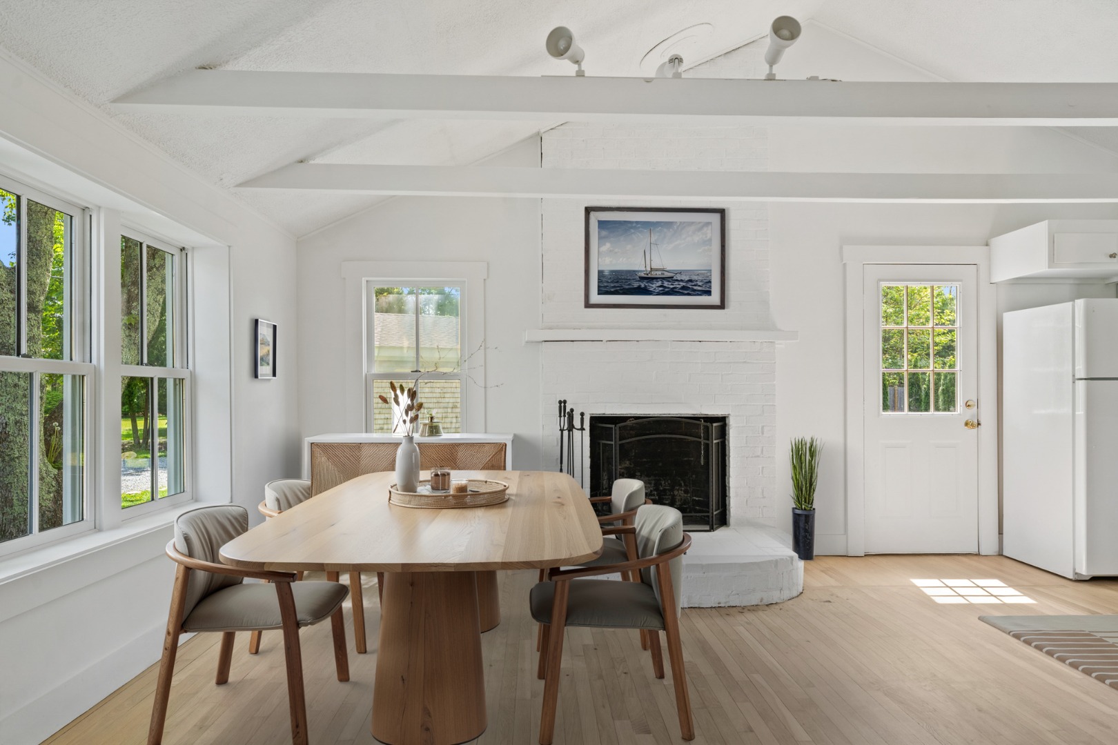 130 Wing Road Oak Bluffs, MA 02557 - Photo 5 of 21 Virtual Staging - Living/Dining room and working fireplace.