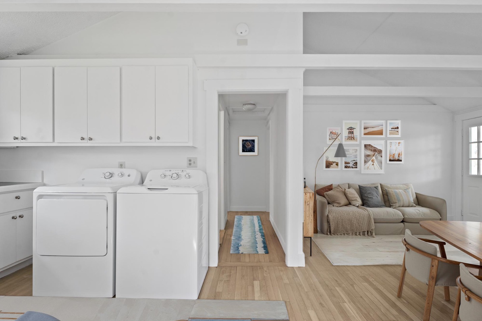 130 Wing Road Oak Bluffs, MA 02557 - Photo 7 of 21 Virtual Staging - Living room at right, hall to bedrooms in center and washer/dryer.