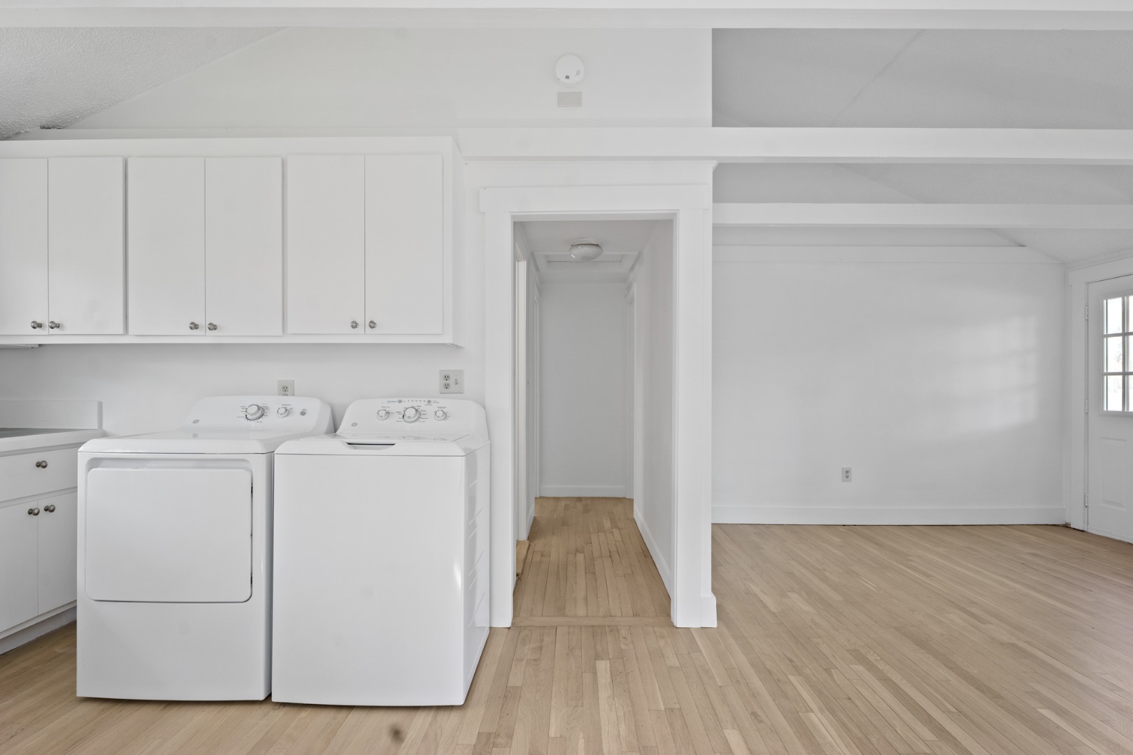 130 Wing Road Oak Bluffs, MA 02557 - Photo 8 of 21 Living room at right, hall to bedrooms in center and washer/dryer.