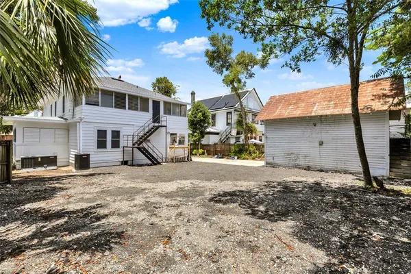 a view of a house with a tree in front