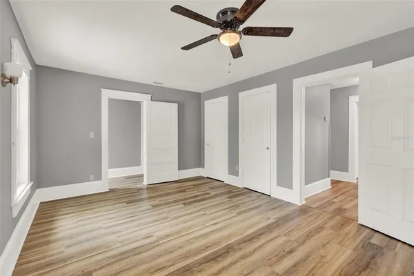 a view of an empty room with wooden floor