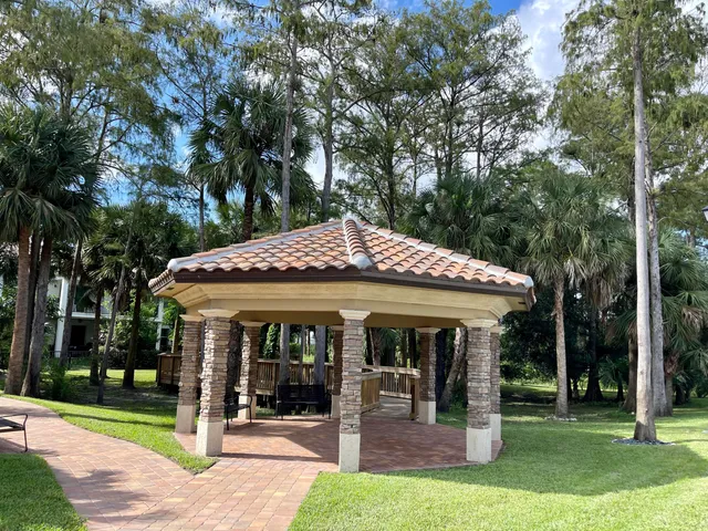 a view of a park with plants and a bench