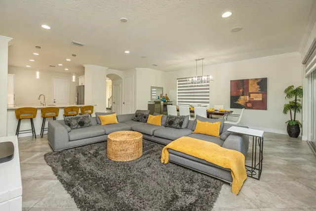 a spacious bedroom with a bed and a flat screen tv